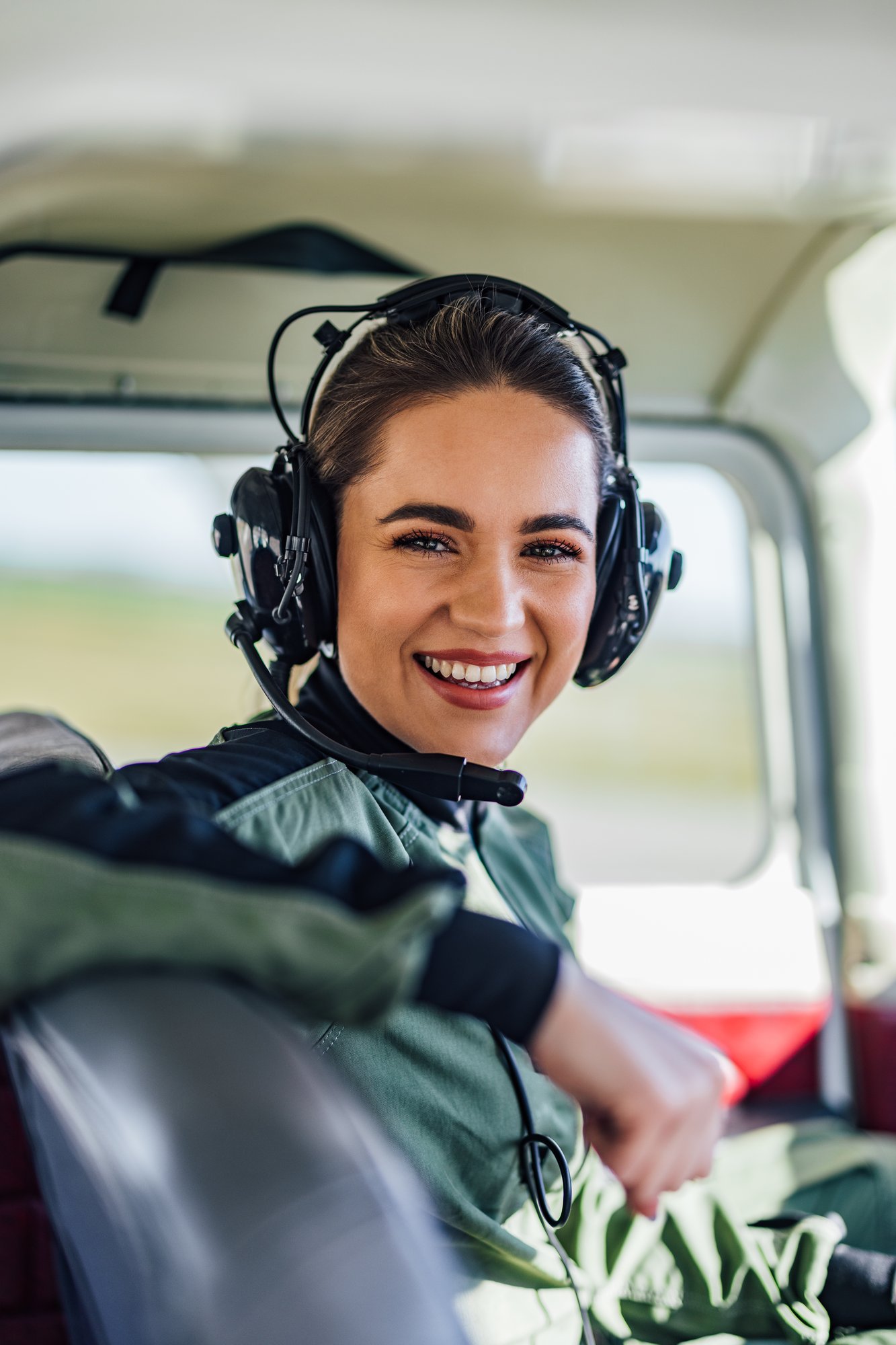 smiling-woman-wearing-headset-inside-airplane-cock-2026-03-20-04-12-18-utc